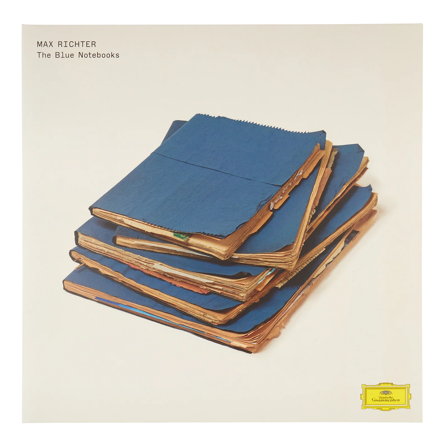 Album cover with stacked blue notebooks and text 'Max Richter The Blue Notebooks' on a beige background