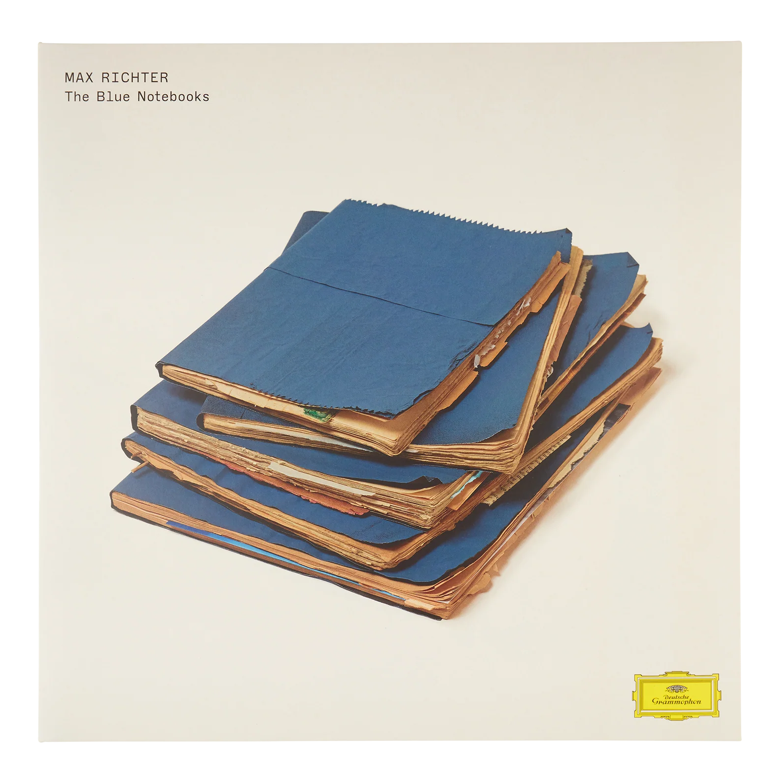 Album cover with stacked blue notebooks and text 'Max Richter The Blue Notebooks' on a beige background